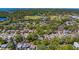 A high-angle, tree-covered view of houses in a residential neighborhood, park, and distant waterfront at 2340 Kingston S St, St Petersburg, FL 33711
