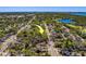 Aerial view of a residential neighborhood, showing the house's location with arrow, surrounded by trees and near the waterfront at 2340 Kingston S St, St Petersburg, FL 33711