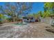 Wide backyard featuring mature trees and a charming single-story home with a screened-in porch at 2340 Kingston S St, St Petersburg, FL 33711