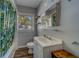 Charming bathroom featuring hardwood floors, ample lighting, and modern fixtures at 2340 Kingston S St, St Petersburg, FL 33711