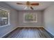 Bedroom with hardwood floors, modern ceiling fan, and natural lighting at 2340 Kingston S St, St Petersburg, FL 33711