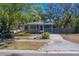 Charming home with a front porch, driveway, and mature trees enhancing its curb appeal at 2340 Kingston S St, St Petersburg, FL 33711