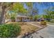 Quaint one-story house with a cozy porch and a green bush in the yard at 2340 Kingston S St, St Petersburg, FL 33711