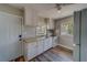 A kitchen featuring bright white cabinets, modern appliances, and hardwood floors at 2340 Kingston S St, St Petersburg, FL 33711
