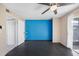 Bedroom features a closet, a blue accent wall, and a door to the outside at 24862 Us Highway 19 Unit N # 2001, Clearwater, FL 33763