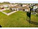 Aerial view of fenced backyards, green grass, screened patios, and neighborhood homes at 3097 Storybrook Preserve Dr, Odessa, FL 33556