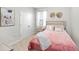 Cozy bedroom features plush pink bedding, neutral walls and carpet, and closet with double doors at 3097 Storybrook Preserve Dr, Odessa, FL 33556