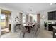 Inviting dining room with elegant chandelier, neutral colors, and a view of the patio at 3097 Storybrook Preserve Dr, Odessa, FL 33556