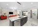 Modern kitchen island with granite countertops, stainless steel dishwasher and stylish pendant lighting at 3097 Storybrook Preserve Dr, Odessa, FL 33556