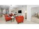 Cozy living room featuring tiled floors, modern furniture, and a stylish accent wall at 3097 Storybrook Preserve Dr, Odessa, FL 33556