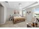 Serene main bedroom with plush carpeting, tray ceiling, and a large window with natural light at 3097 Storybrook Preserve Dr, Odessa, FL 33556