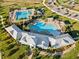 Aerial view of community pool with multiple lounge areas and ample parking at recreation center at 3097 Storybrook Preserve Dr, Odessa, FL 33556