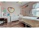 Bedroom featuring a four-poster bed frame, a vanity table, and wood laminate flooring at 31707 Holcomb Pass, Wesley Chapel, FL 33543