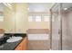 Bathroom with walk-in shower, soaking tub, and single sink with granite counters at 3405 W Swann Ave # 9, Tampa, FL 33609