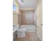 Neutral bathroom featuring a shower and tub combination, and a toilet and sink at 3405 W Swann Ave # 9, Tampa, FL 33609