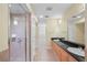 Bathroom featuring a walk-in shower and double sinks with granite counters at 3405 W Swann Ave # 9, Tampa, FL 33609