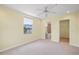 Bright bedroom with a ceiling fan, window, and bathroom and closet access at 3405 W Swann Ave # 9, Tampa, FL 33609