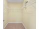 Walk-in closet with white wire shelving on three walls and a tan carpet at 3405 W Swann Ave # 9, Tampa, FL 33609