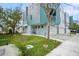 Modern townhome with a blue accent wall and attached garages on a landscaped lot at 3405 W Swann Ave # 9, Tampa, FL 33609