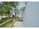 Exterior shot of a sidewalk leading to a door with a safety handrail and tropical landscaping at 3405 W Swann Ave # 9, Tampa, FL 33609