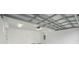 Spacious and clean garage featuring exposed ceiling and utility door at 3405 W Swann Ave # 9, Tampa, FL 33609