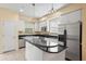 Kitchen with breakfast bar, white cabinets and stainless steel appliances at 3405 W Swann Ave # 9, Tampa, FL 33609