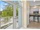 View from patio into kitchen featuring white cabinets and stainless appliances at 3405 W Swann Ave # 9, Tampa, FL 33609