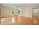 Spacious living room with hardwood floors, a ceiling fan, and access to a balcony with natural light at 3405 W Swann Ave # 9, Tampa, FL 33609