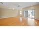 Open living space with hardwood floors, ceiling fan and a sliding glass door leading to a patio at 3405 W Swann Ave # 9, Tampa, FL 33609