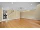 Open-concept living room with hardwood floors leading into the kitchen and staircase at 3405 W Swann Ave # 9, Tampa, FL 33609