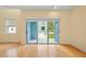 Bright living room with hardwood floors, sliding glass doors to a patio, and ample natural light at 3405 W Swann Ave # 9, Tampa, FL 33609