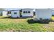 Exterior view of the home's backyard, showcasing the shed and well-manicured lawn at 37235 Cora Ave, Zephyrhills, FL 33542
