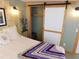A bright bedroom with closet with sliding door, and decorative touches for a comfortable and stylish retreat at 37235 Cora Ave, Zephyrhills, FL 33542