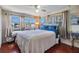 Inviting bedroom with large windows, ceiling fan and hardwood floors at 37235 Cora Ave, Zephyrhills, FL 33542