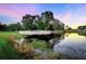 Botmar Golf Club sign reflecting in a pond surrounded by lush greenery at dusk at 37235 Cora Ave, Zephyrhills, FL 33542