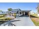 Charming single-story home featuring a covered carport and landscaped front yard at 37235 Cora Ave, Zephyrhills, FL 33542