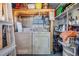 Practical laundry room with washer, dryer, storage shelves, and utility sink at 37235 Cora Ave, Zephyrhills, FL 33542