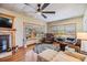 Bright living room featuring cozy seating and a fireplace, perfect for relaxing at 37235 Cora Ave, Zephyrhills, FL 33542