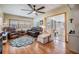 Comfortable living room featuring cozy seating and access to the sunroom at 37235 Cora Ave, Zephyrhills, FL 33542