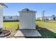 Exterior view of the storage shed with concrete tile entrance at 37235 Cora Ave, Zephyrhills, FL 33542