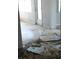 Damaged living room featuring severe destruction and debris on the floors, walls and ceiling at 390 Belle Point Dr, St Pete Beach, FL 33706