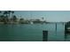 Picturesque waterfront view featuring docks, boats, and serene water under a bright sky at 390 Belle Point Dr, St Pete Beach, FL 33706