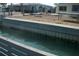 Beautiful waterfront view showcasing a retaining wall along the canal, offering serene water access at 390 Belle Point Dr, St Pete Beach, FL 33706