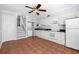 Modern kitchen with white cabinets, updated appliances, tiled floor, and staircase at 4228 La Dega Ct, Tampa, FL 33611