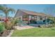 Inviting backyard patio with colorful chairs, lush landscaping, and charming curb appeal at 440 Pendleton Dr, Venice, FL 34292