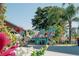 Relaxing backyard patio featuring colorful Adirondack chairs, blooming flowers, and curb appeal at 440 Pendleton Dr, Venice, FL 34292