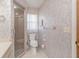 Bathroom with floral wallpaper, includes a shower, toilet and vanity with sink, ensuring comfort and functionality at 440 Pendleton Dr, Venice, FL 34292