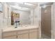 Bathroom features a vanity, ample lighting, and a glass-enclosed shower, providing a clean and functional space at 440 Pendleton Dr, Venice, FL 34292