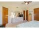 Cozy bedroom features a ceiling fan, light walls, and an oval mirror on top of a dresser at 440 Pendleton Dr, Venice, FL 34292