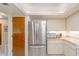 Kitchen features stainless steel refrigerator and lots of white counterspace and cabinets at 440 Pendleton Dr, Venice, FL 34292
